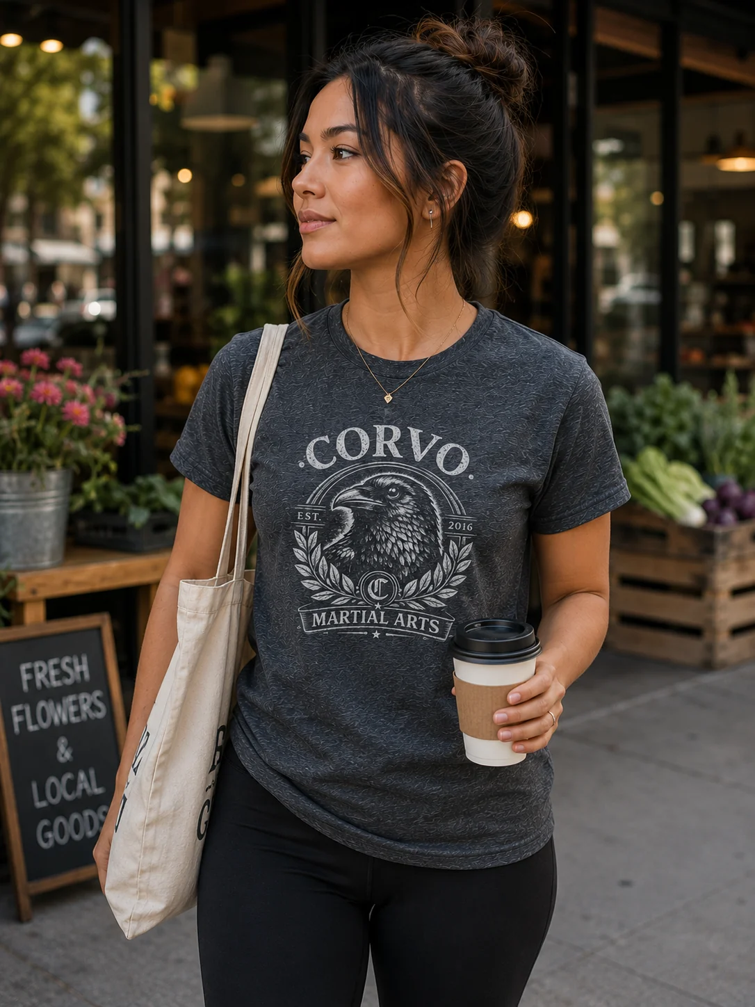 Woman wearing the distressed Corvo Martial Arts Heritage Crow shirt outdoors.